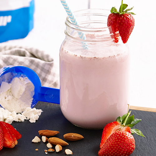 image of strawberry meal replacement shakes with real strawberries nuts and protein powder on a slate